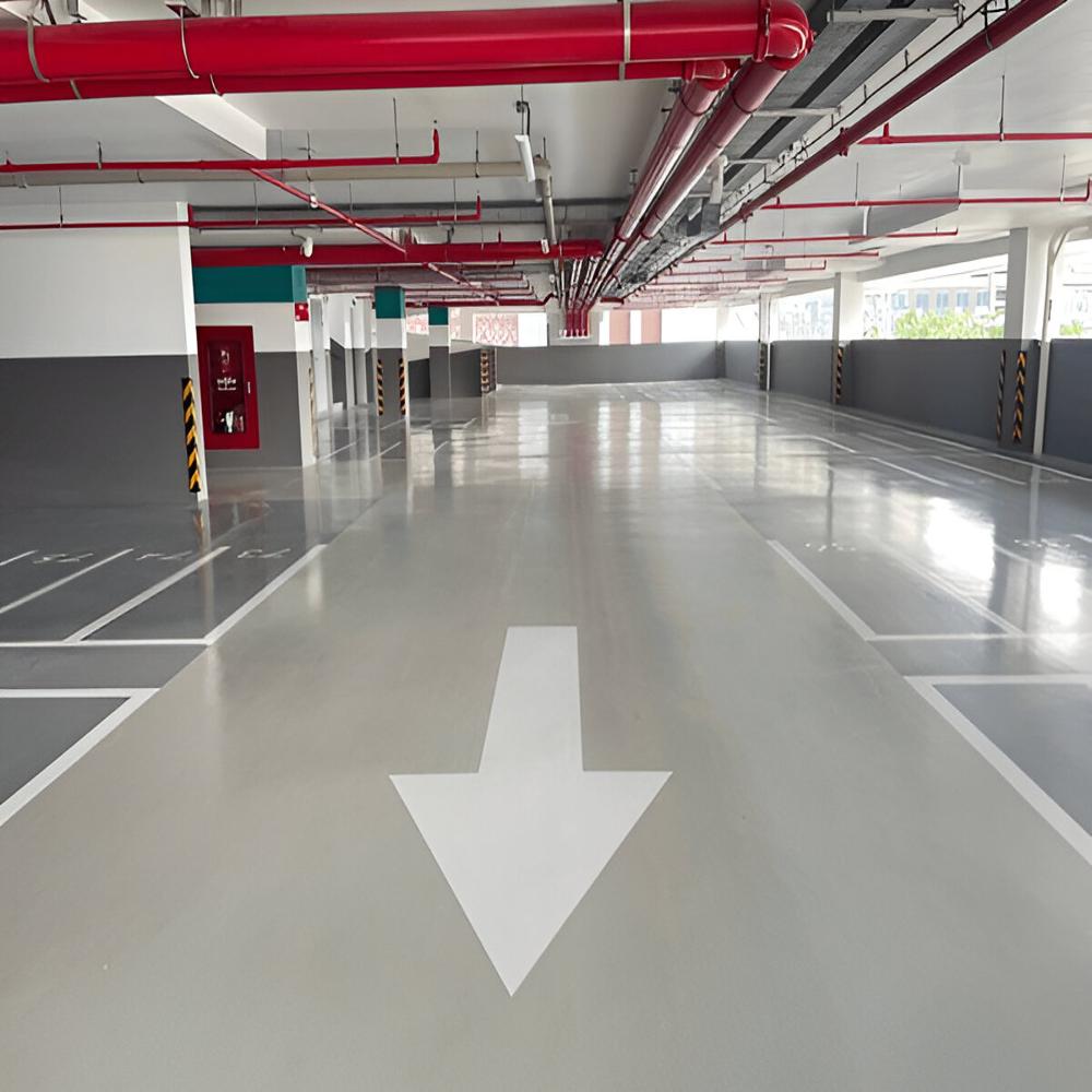 Completed smooth epoxy car-park drive aisle with directional marking